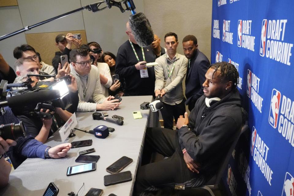 Bronny James, right, listens to a reporter's question during a media session at the NBA draft combine Tuesday in Chicago.