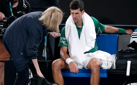 Djokovic is seen by the doctor during the changeover - Credit: AP