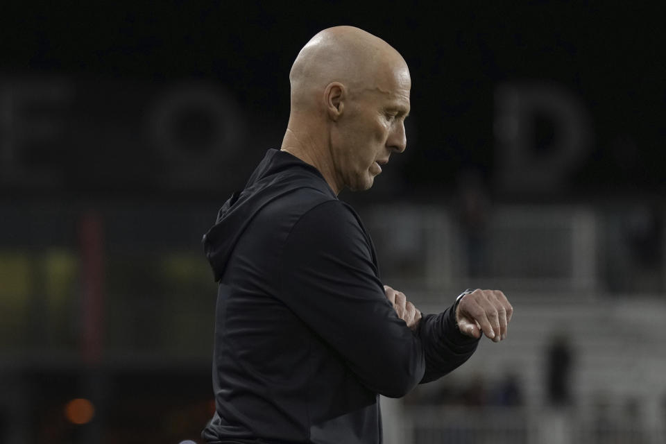 Toronto FC head coach Bob Bradley checks his watch as his team closes in on a win over DC United in MLS soccer match action in Toronto, Ontario, Saturday, May 27, 2023. (Chris Young/The Canadian Press via AP)
