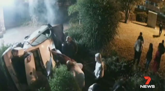 Onlookers rushed to the scene to rescue the trapped 18-year-old from under the car. Source: 7News