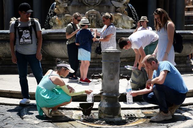 Tourists drink and fill their bottle from a public fountain to refresh themselves during an unusually early summer heatwave on June 24, 2019 in Rome. - Fans flew off store shelves and public fountains offered relief from the heat as temperatures soared in Europe on June 24, with officials urging vigilance ahead of even hotter conditions forecast later in the week. Meteorologists blamed a blast of torrid air from the Sahara for the unusually early summer heatwave, which could send thermometers up to 40 degrees Celsius (104 Fahrenheit) across large swathes of the continent. (Photo by Alberto PIZZOLI / AFP)        (Photo credit should read ALBERTO PIZZOLI/AFP via Getty Images) (Photo: ALBERTO PIZZOLI via Getty Images)