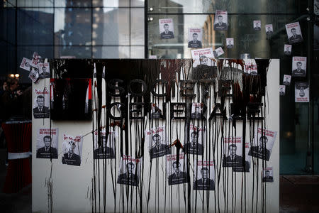 The Societe Generale logo is covered by molasses representing oil as Environmental activists block the entrance to the headquarters of the French bank Societe Generale during a "civil disobedience action" to urge world leaders to act against climate change, in La Defense near Paris, France, April 19, 2019. REUTERS/Benoit Tessier