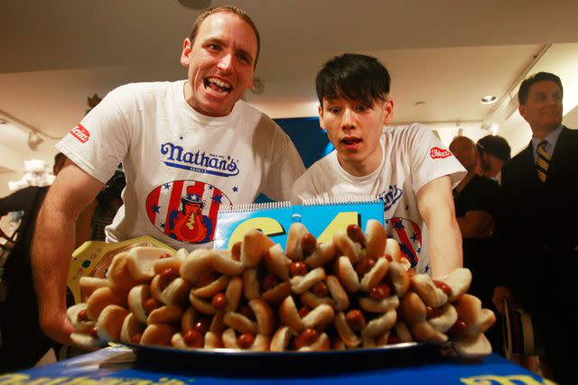 <p>Mario Tama/Getty</p> Joey Chestnut (left) and Takeru Kobayashi in 2009