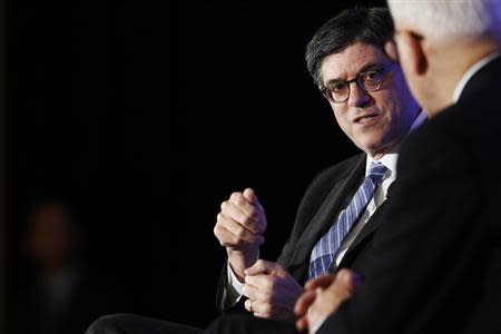 U.S. Treasury Secretary Jack Lew (2nd R) speaks with Carlyle Group co-CEO David Rubenstein (R) during an onstage interview at the Economic Club of Washington D.C., in Washington, September 17, 2013. REUTERS/Jonathan Ernst