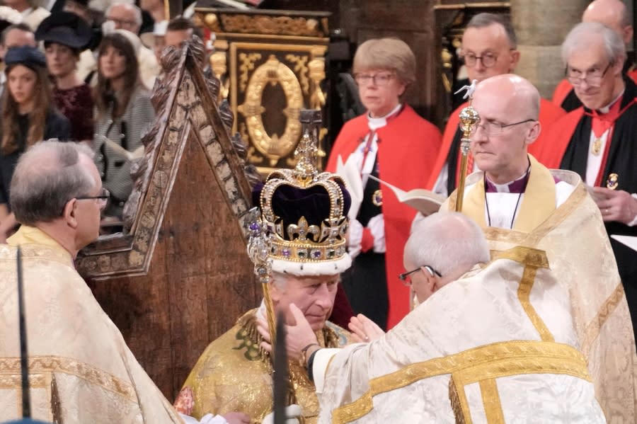 King Charles III sits as he is crowned with St Edward's Crown by The Archbishop of Canterbury the Most Reverend Justin Welby during the coronation ceremony at Westminster Abbey, London, Saturday, May 6, 2023. (Jonathan Brady/Pool Photo via AP)