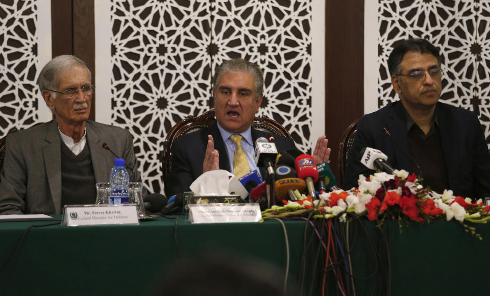 Pakistani Foreign Minister Shah Mahmood Qureshi, center, gives a press conference with Defense Minister Pervez Khattak, left, and Finance Minister Asad Umar after a recent Indian airstrike, in Islamabad, Pakistan, Tuesday, Feb. 26, 2019. Pakistan said India launched an airstrike on its territory early Tuesday that caused no casualties, while India said it targeted a terrorist training camp in a pre-emptive strike that killed a "very large number" of militants. (AP Photo/Anjum Naveed)