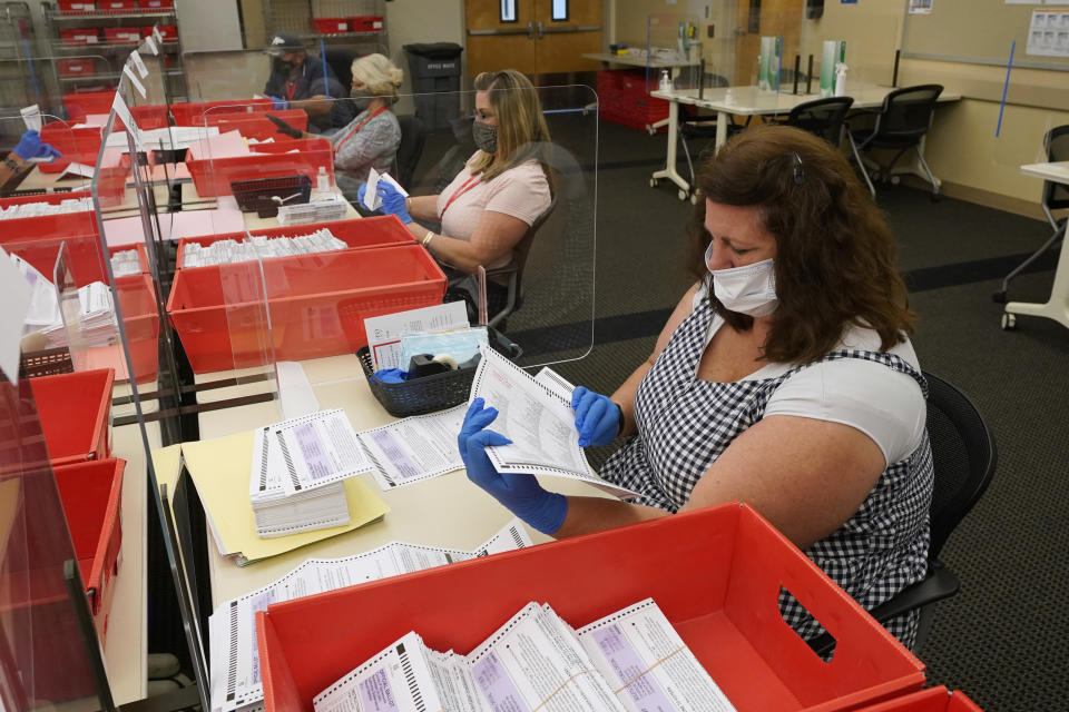 Election workers inspect ballots for damage that have been received for the Sept. 14, recall election at the Sacramento County Registrar of Voters office in Sacramento, Calif., Monday, Aug. 30, 2021. California voters have until Sept. 14 to cast their ballots to either keep Gov. Gavin Newsom in office are replace him with one of over 40 candidates on the recall ballot. In a state dominated by Democrats the outcome will depend on who takes the time to vote. (AP Photo/Rich Pedroncelli)