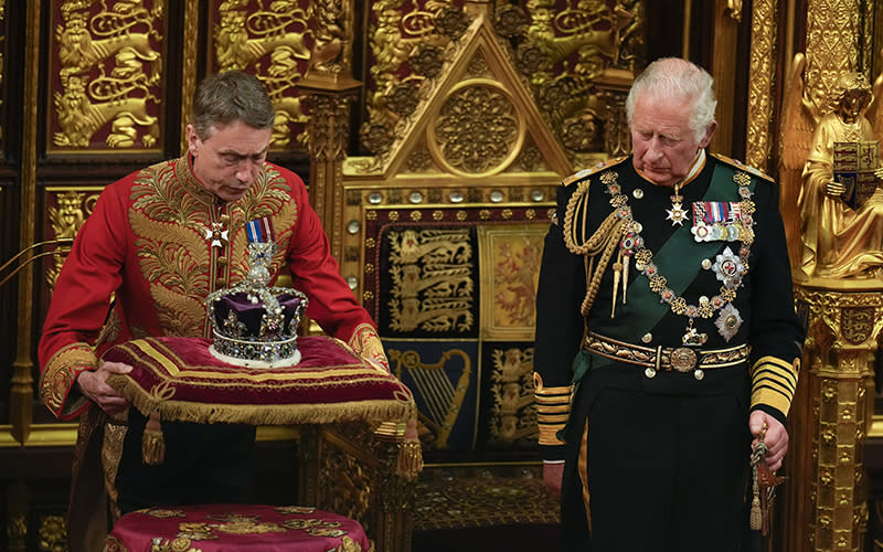 Britain’s Prince Charles watches as the crown of Queen Elizabeth II is placed on a pillow