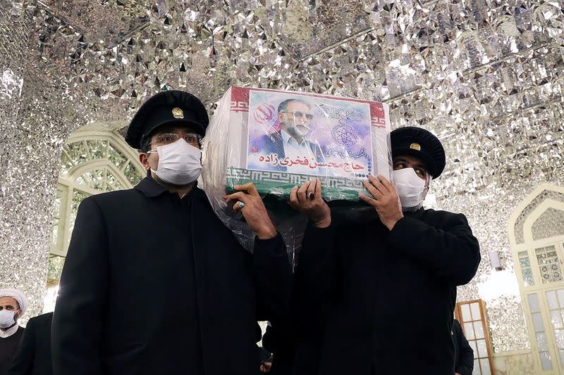 Servants of the holy shrine of Imam Reza carry the coffin of Iranian nuclear scientist Mohsen Fakhrizadeh, in Mashhad