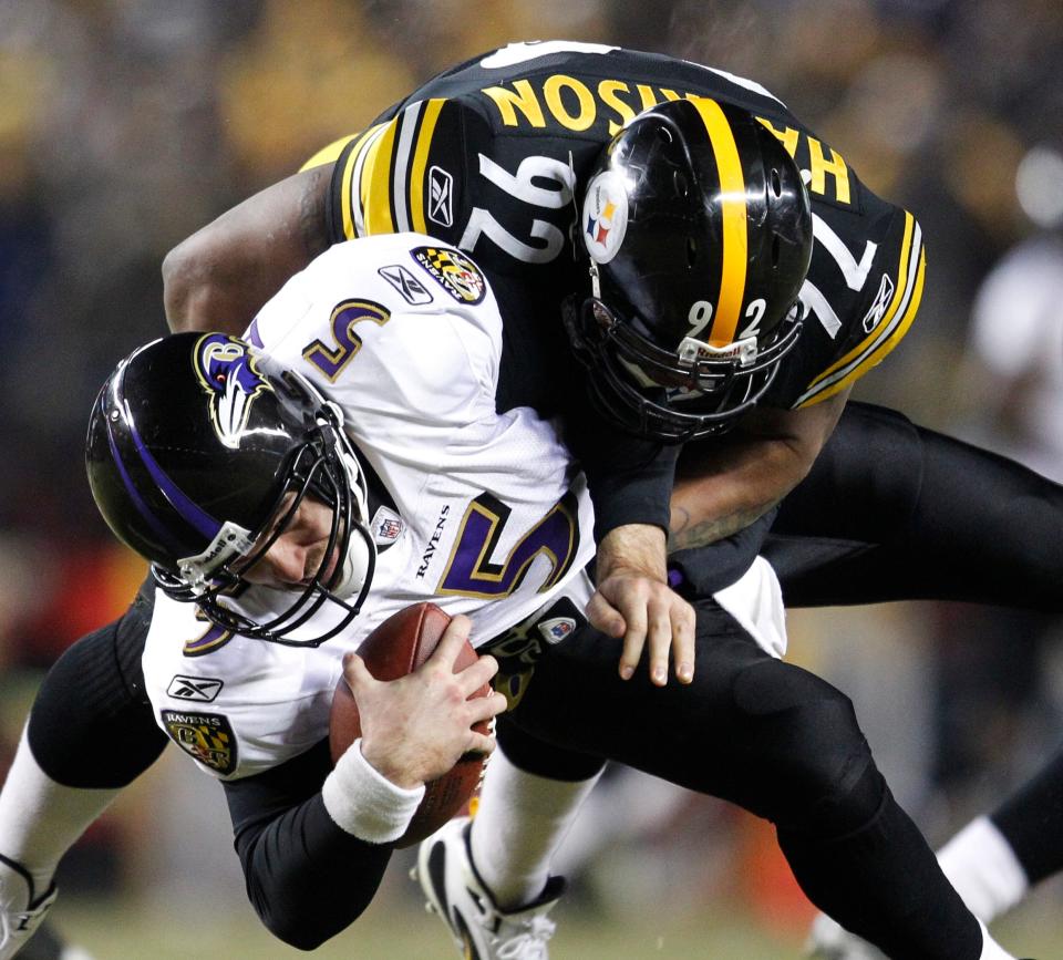 Baltimore Ravens quarterback Joe Flacco (5) is sacked by Pittsburgh Steelers linebacker James Harrison (92) during a divisional-round playoff game Jan. 15, 2011, in Pittsburgh.