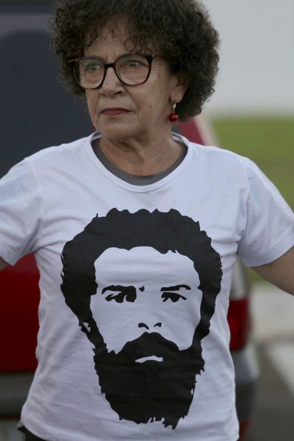 A supporter of Brazil's Former President Luiz Inacio Lula da Silva, sports a T-shirt with da Silva's image on it during a protest in front of the Superior Electoral Tribunal, as the trial against the candidacy of the jailed former president continues, in Brasilia, Brazil, Friday, Aug. 31, 2018. Brazil's general elections will be held on October 7. (AP Photo/Eraldo Peres)