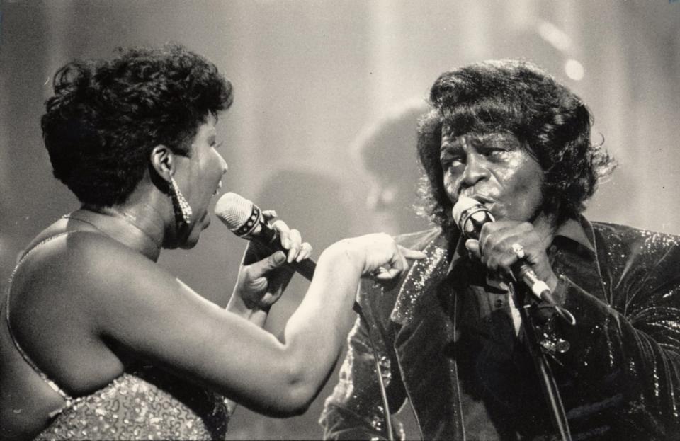 James Brown, right, performs with Aretha Franklin in Detroit in January 1987. Brown got his start recording with King Records in Cincinnati's Evanston neighborhood.