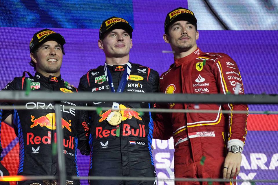 Winner Red Bull driver Max Verstappen of the Netherlands, center, celebrates on the podium flanked by second place Red Bull driver Sergio Perez of Mexico, led, and third place Ferrari driver Charles Leclerc of Monacoon the podium of the Formula One Saudi Arabian Grand Prix at the Jeddah Corniche Circuit, in Jedda, Saudi Arabia, Saturday, March 9, 2024. (AP Photo/Darko Bandic)