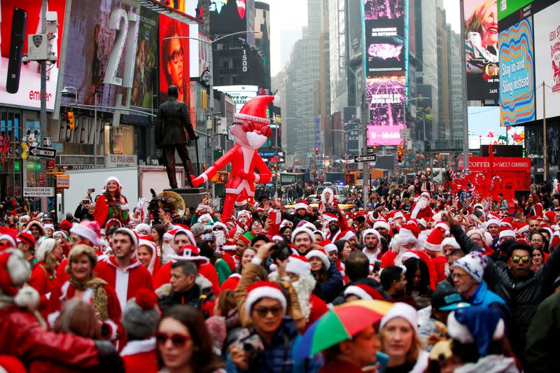 FILE PHOTO: Revelers dressed as Santa Claus take part in the event called SantaCon at Times Square in New York
