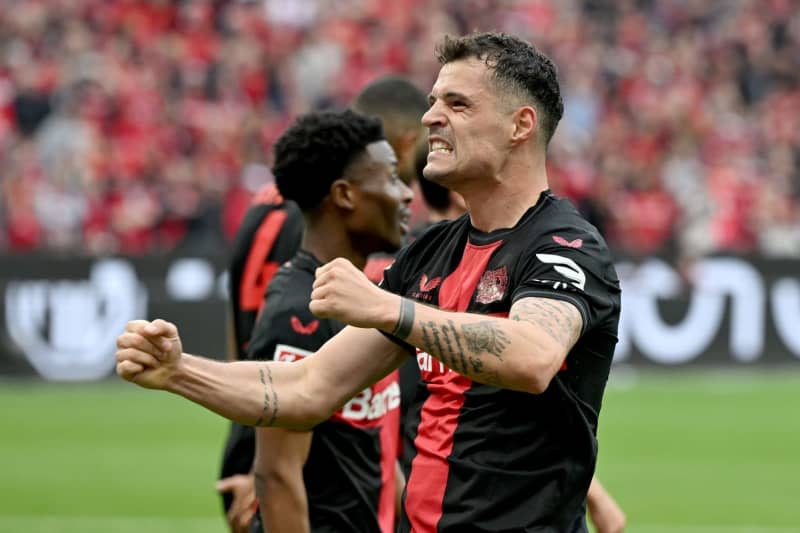 Leverkusen's Granit Xhaka (R) celebrates scoring his side's second goal during the German Bundesliga soccer match between Bayer 04 Leverkusen and SV Werder Bremen at BayArena. Federico Gambarini/dpa