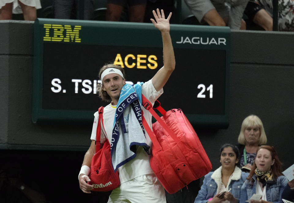 Greece's Stefanos Tsitsipas waves to the crowd after losing to Australia's Nick Kyrgios during their third round men's singles match on day six of the Wimbledon tennis championships in London, Saturday, July 2, 2022. (AP Photo/Kirsty Wigglesworth)