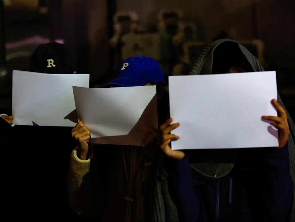 Demonstrators hold white sheets of paper in a solidarity protest against China's coronavirus lockdowns near the Chinese Embassy in Tokyo in November. 