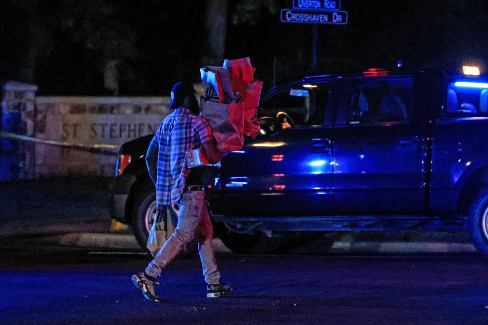 Residents walk home form a local store as police barricade off the area after a shooting at the Saint Stevens Episcopal Church on Thursday, June 16, 2022 in Vestavia, Ala. (AP Photo/Butch Dill)