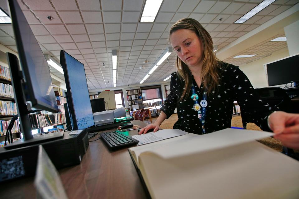 New Bedford public library reference librarian, Amy Ferguson, searches for an online requested Standard-Times obituary using the new microfilm scanner available at the downtown branch.