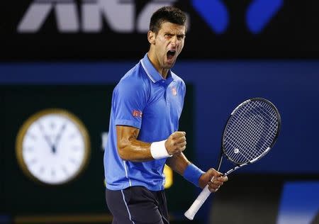 Novak Djokovic of Serbia celebrates winning a point against Stan Wawrinka of Switzerland during their men's singles semi-final match at the Australian Open 2015 tennis tournament in Melbourne January 30, 2015. REUTERS/Issei Kato