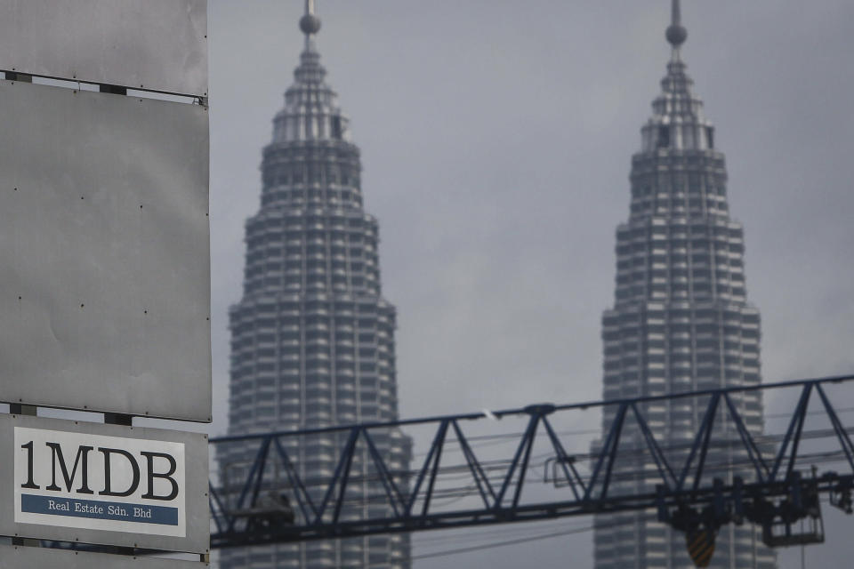 In this Wednesday, July 8, 2015 photo, a 1MDB (1 Malaysia Development Berhad) logo is set against the Petronas Twin Towers at the flagship development site, Tun Razak Exchange in Kuala Lumpur, Malaysia. An indebted Malaysian state investment fund says it will cooperate with Swiss prosecutors whose investigation indicated that $4 billion may have been misappropriated from Malaysian state-owned companies. (AP Photo/Joshua Paul)