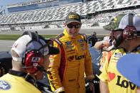 Michael McDowell, center, talks with crew members on pit road during NASCAR auto race qualifying at Daytona International Speedway, Sunday, Feb. 9, 2020, in Daytona Beach, Fla. (AP Photo/John Raoux)