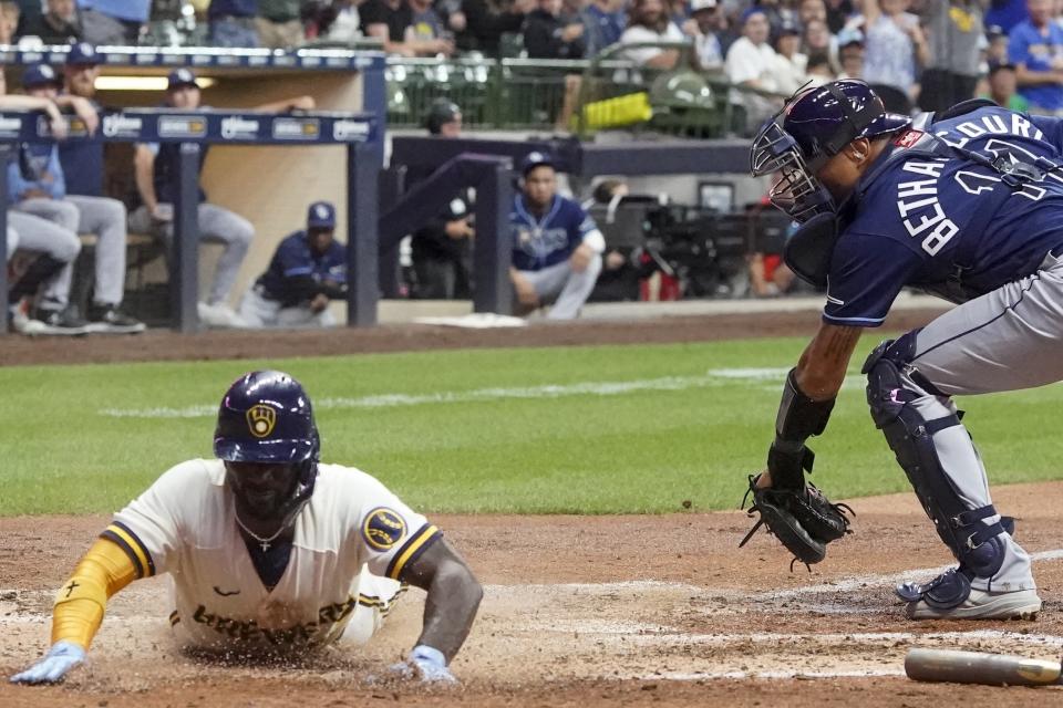 Milwaukee Brewers' Andrew McCutchen scores past Tampa Bay Rays catcher Christian Bethancourt during the fifth inning of a baseball game Tuesday, Aug. 9, 2022, in Milwaukee. McCutchen scored on a hit by Kolten Wong. (AP Photo/Morry Gash)