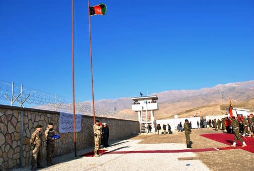 Afghan security officials and NATO personell at a ceremony last December to hand over security control in Aybak, capital of Samangan. A suicide attacker in Aybak on Saturday embraced MP Ahmad Khan, a former militia commander, in front of wedding guests before detonating the explosives strapped around his waist, a security forces spokesman said