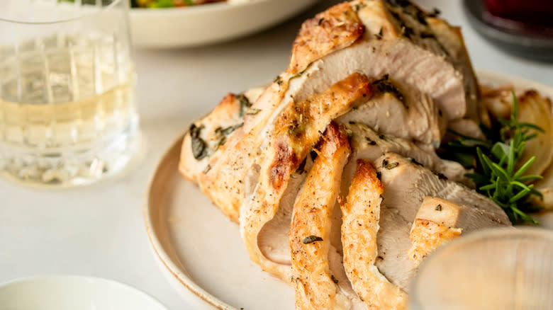 sliced turkey with herbs