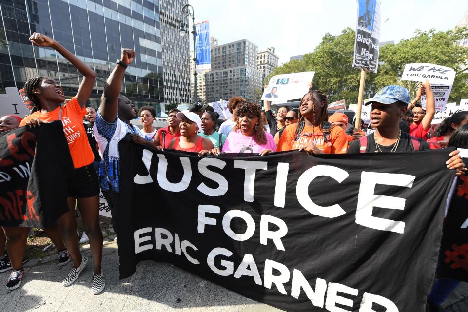 Eric Garner's mother, Gwen Carr, in pink, protests in Foley Square in New York with others on July 17, 2019.
 