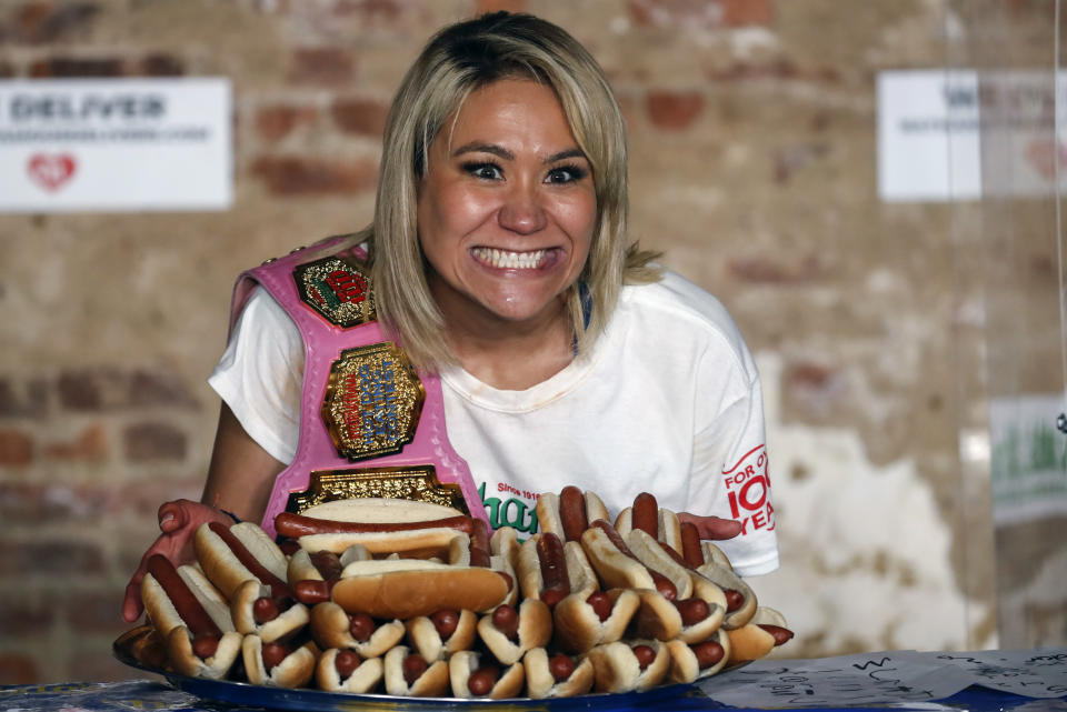 Competitive eater Miki Sudo celebrates after setting the women's world record of 48 and a half hot dogs to win the women's division of the Nathan's Famous July Fourth hot dog eating contest, Saturday, July 4, 2020, in the Brooklyn borough of New York. AP Photo/John Minchillo)