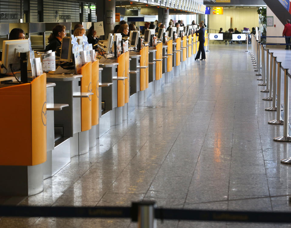 Ticket counters of German Lufthansa airline are empty as public employees of the Frankfurt airport went on a warning strike for higher wages in Frankfurt, Germany, Thursday, March 27, 2014. Lufthansa had to cancel more than 600 flights. (AP Photo/Michael Probst)