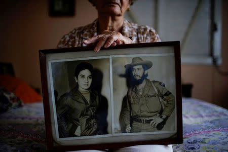 Former rebel Juana Ramirez, 81, shows a photograph of her with her late husband and rebel fighter Luiz Perez, Havana, Cuba, April 4, 2018. Picture taken on April 4, 2018. REUTERS/Alexandre Meneghini