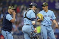 Toronto Blue Jays starting pitcher Yusei Kikuchi, right, alks with catcher Danny Jansen, center, as pitching coach Pete Walker, left, visits the mound during first-inning baseball game action against the Cincinnati Reds in Toronto, Sunday, May 22, 2022. (Frank Gunn/The Canadian Press via AP)