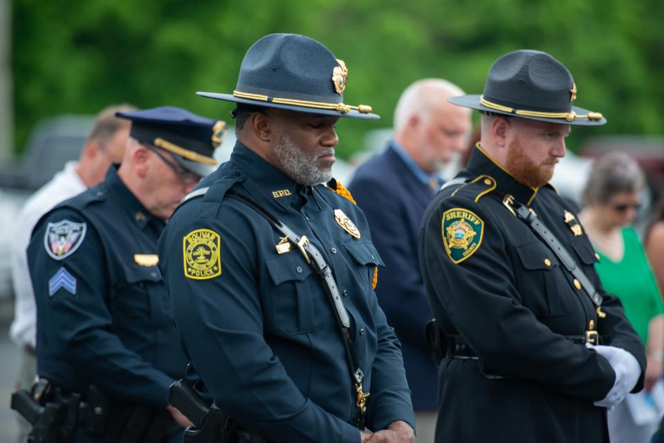 Officers bow their heads as Jackson Chaplain Ronald Benton leads prayer during the National Law Enforcement Memorial Service at Madison County Sheriff's Office in Denmark, Tenn. on Friday, May 19, 2023.