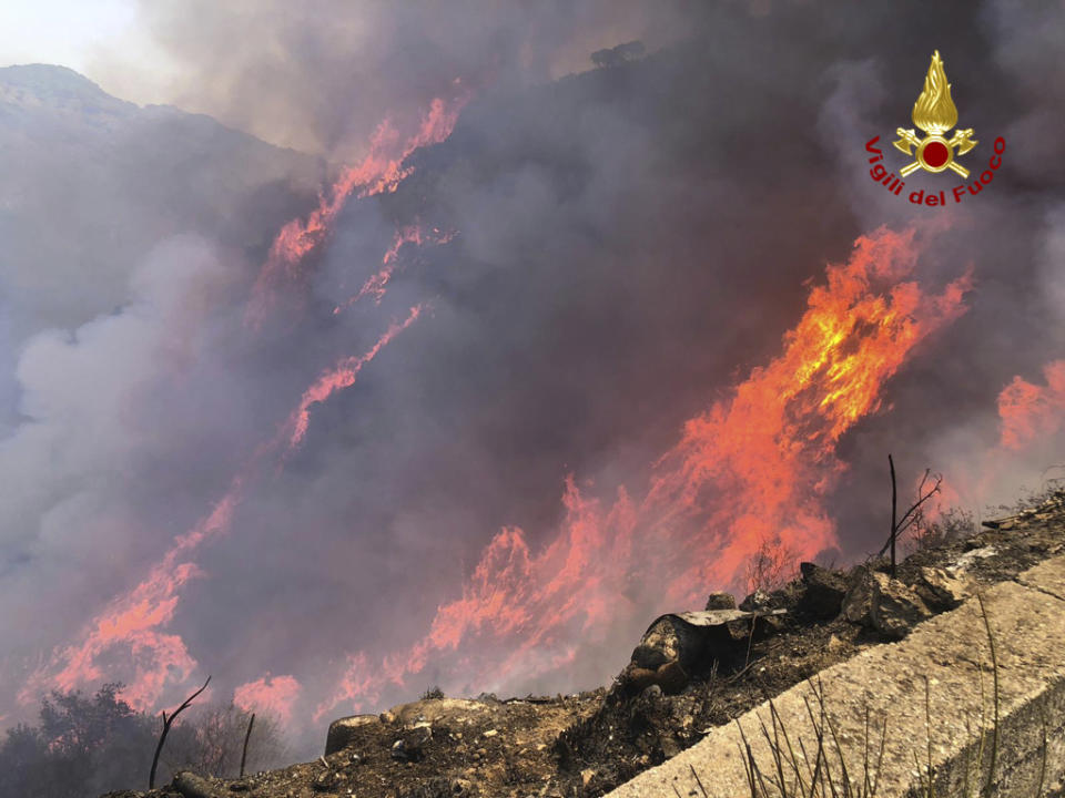 This picture released by the Italian firefighters shows wildfires in the region of Palermo in Sicily, Italy, Tuesday July 25, 2023. (Italian Firefighters - Vigili del Fuoco via AP)