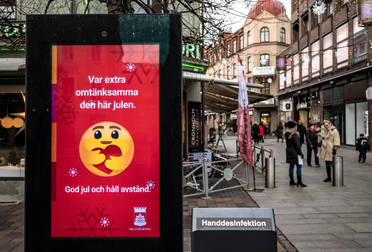 An information sign wishing Merry Christmas and asking to maintain social distancing is seen in a pedestrian shopping street in Helsingborg, southern Sweden, on December 7, 2020. - The last week in November, Helsingborg had more new confirmed Covid-19 cases than in any other city in Sweden. (Photo by Johan NILSSON / TT News Agency / AFP) / Sweden OUT (Photo by JOHAN NILSSON/TT News Agency/AFP via Getty Images)
