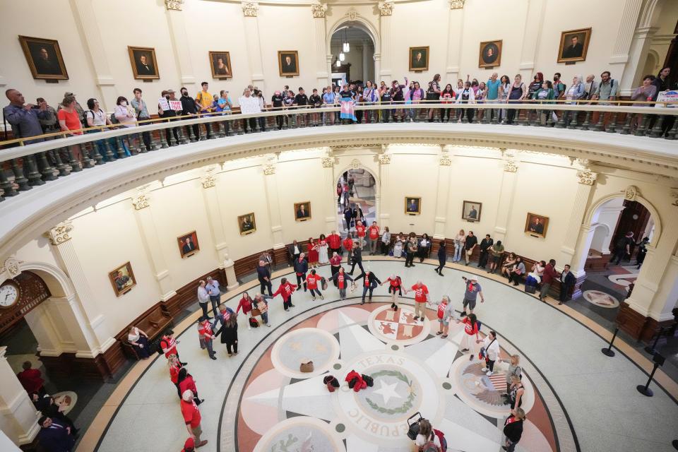 LGBTQ+ rights activists on May 2, 2023, protest Senate Bill 14 on the second floor of the Capitol Rotunda as American Principles Project members pray on the first floor. SB14 banned gender-affirming medical care for transgender children.