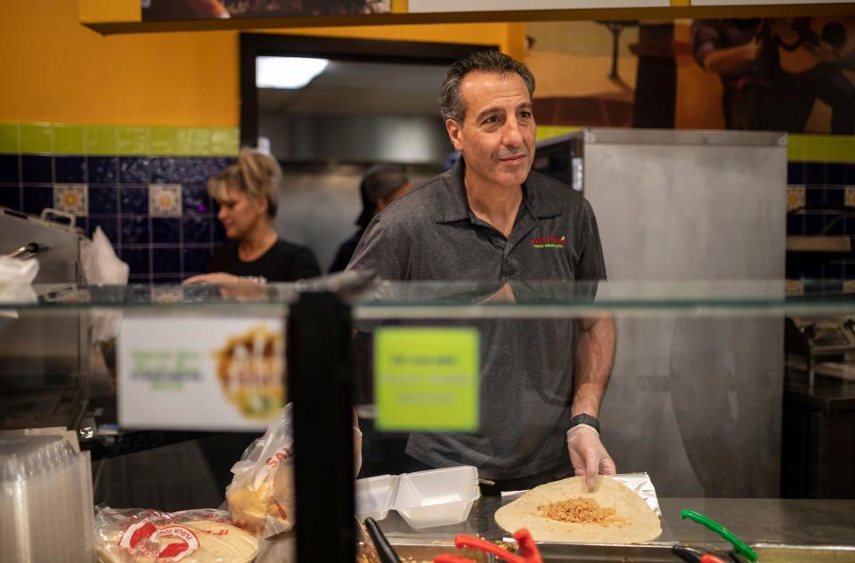 Steve Alie, the owner of Salsarita's Fresh Mexican Grill, takes a customer's order during lunchtime inside the Renaissance Center in Detroit on Wednesday, Feb. 28, 2024.