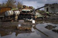 Russian tanks damaged in recent fighting are seen near the recently retaken village of Kamianka, Kharkiv region, Ukraine, Sunday, Oct. 30, 2022.(AP Photo/Efrem Lukatsky)