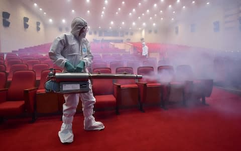 MERS continues to be a issue worldwide. This image shows a health worker fumigating a theatre in Seoul, South Korea, in 2015  - Credit: JUNG YEON-JE/AFP