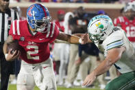 Mississippi quarterback Matt Corral (2) stiff-arms a Tulane defender during the first half of an NCAA college football game, Saturday, Sept. 18, 2021, in Oxford, Miss. (AP Photo/Rogelio V. Solis)