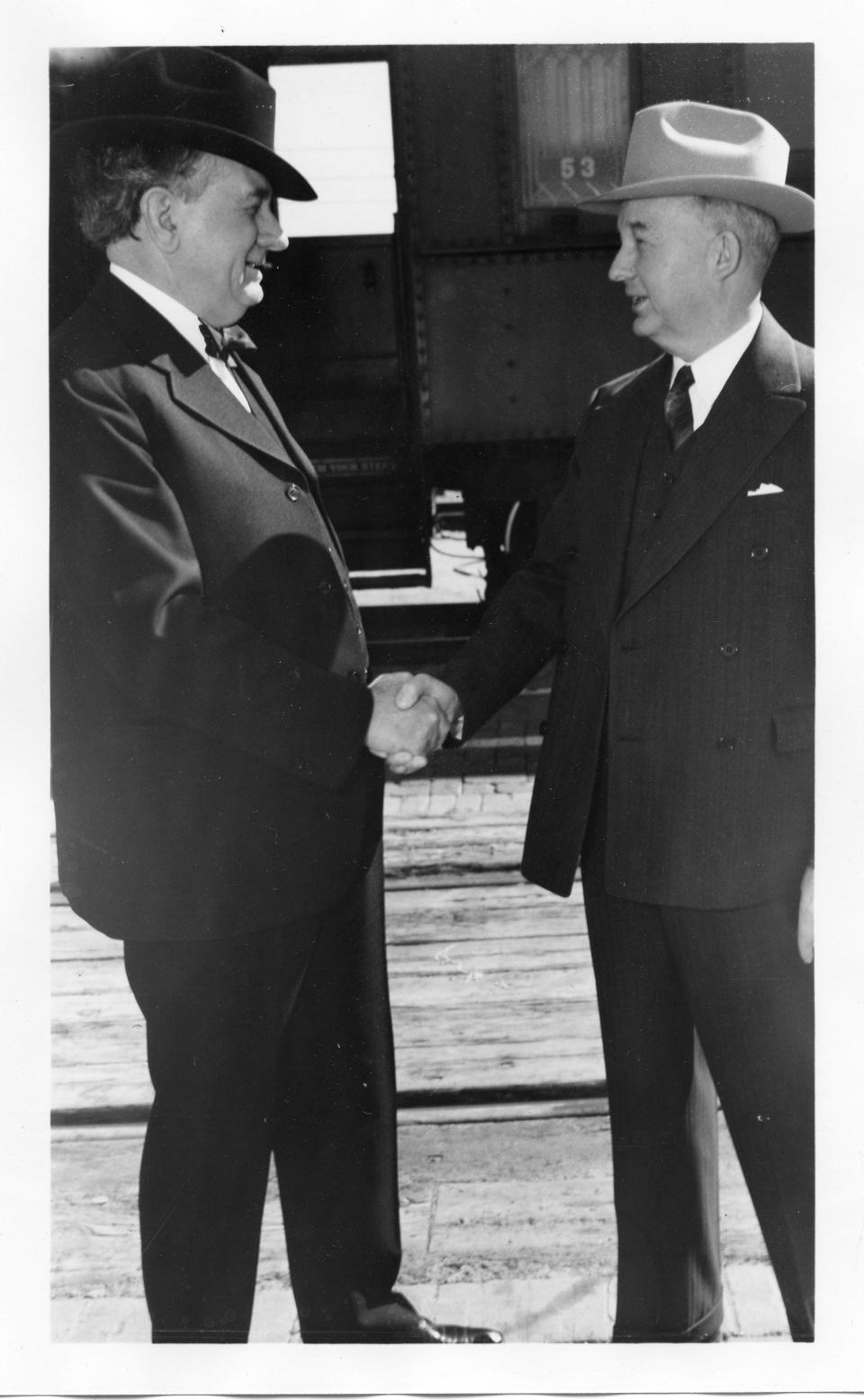 Marvin Jones and Tom Connally shake hands.