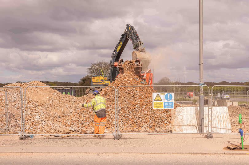 pile of bricks and workmen