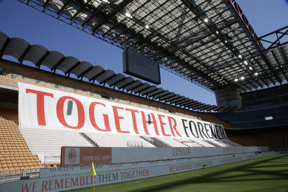 A giant banner is displayed during the Serie A soccer match between AC Milan and Roma, at the San Siro Stadium in Milan, Sunday, June 28, 2020. It was Milan's first home match since the lockdown and the team put up a huge banner along one side of the empty San Siro stadium that read “Together Forever,” dedicated to coronavirus victims. The Lombardy region of which Milan is the capital was the hardest hit area in Italy with more than 16,000 deaths. (AP Photo/Luca Bruno)