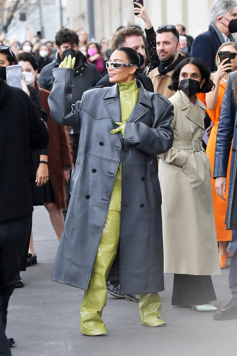 Kim Kardashian in an all-green suit with long black leather jacket