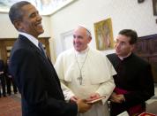 FILE - In this March 27, 2014 file photo, President Barack Obama, left, reacts as he meets with Pope Francis, center, during their exchange of gifts at the Vatican. President Joe Biden is scheduled to meet with Pope Francis on Friday, Oct. 29, 2021. Biden is only the second Catholic president in U.S. history. (AP Photo/Pablo Martinez Monsivais, File)