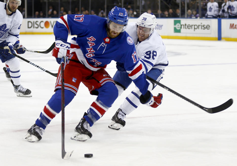 New York Rangers' Ryan Strome (17) skates with the puck past Toronto Maple Leafs' Rasmus Sandin (38) during the second period of an NHL hockey game Wednesday, Jan. 19, 2022, in New York. (AP Photo/John Munson)