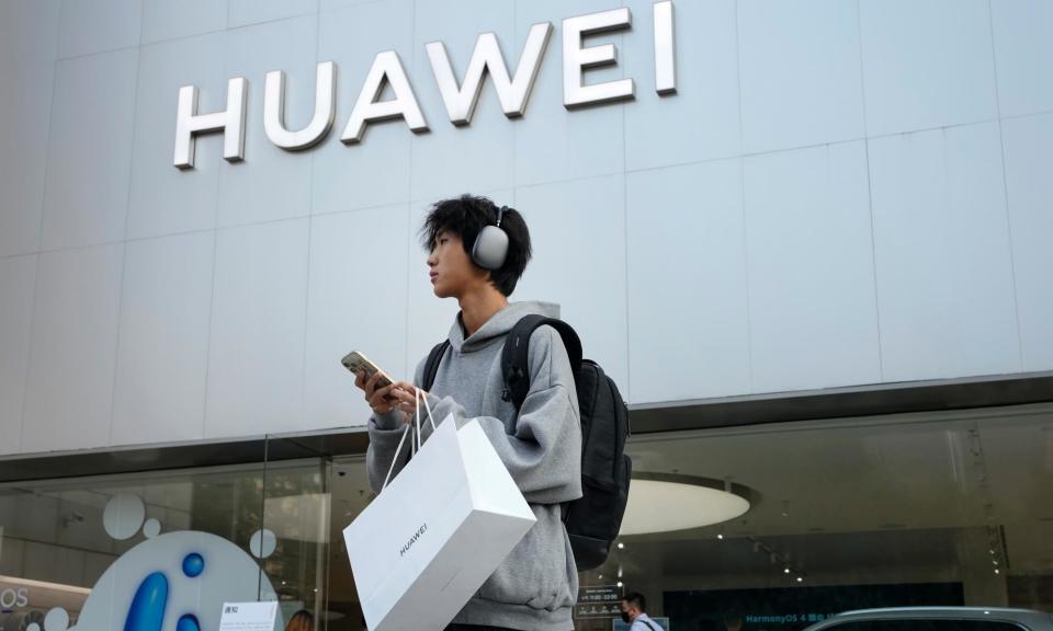 <span>A customer outside a Huawei store in Beijing. </span><span>Photograph: Andy Wong/AP</span>