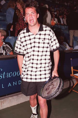 <p>Getty</p> Matthew Perry at a charity tennis game in 1995.